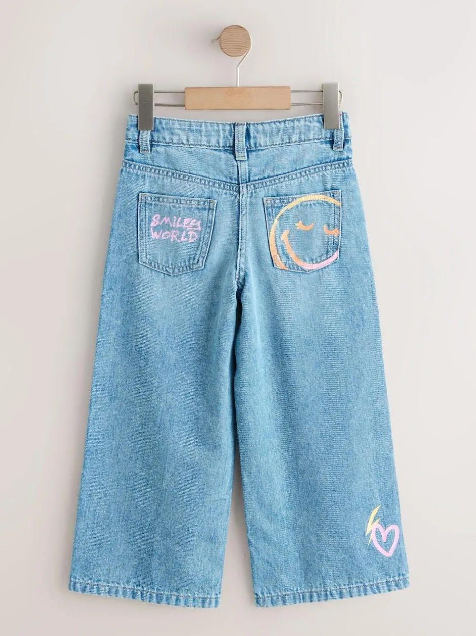 Next Mid Blue SmileyWorld® Print Wide Leg Jeans (3-16yrs) Online