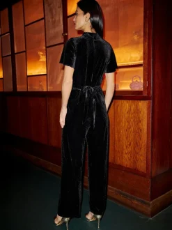 Yumi Black Velvet Jumpsuit With Twist Neckline And Buckle Belt